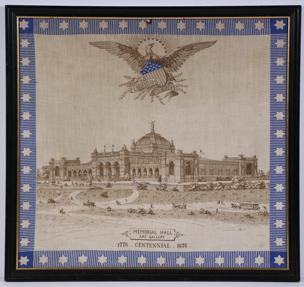 PRINTED COTTON HANDKERCHIEF, 1876 PHILADELPHIA: In brown and blue on white, depicting the Memorial Hall Art Gallery, marked 1776 Centennial 1876, with American Eagle above, blue starred band at border, in black molded frame under glass, OS: 22" x 2