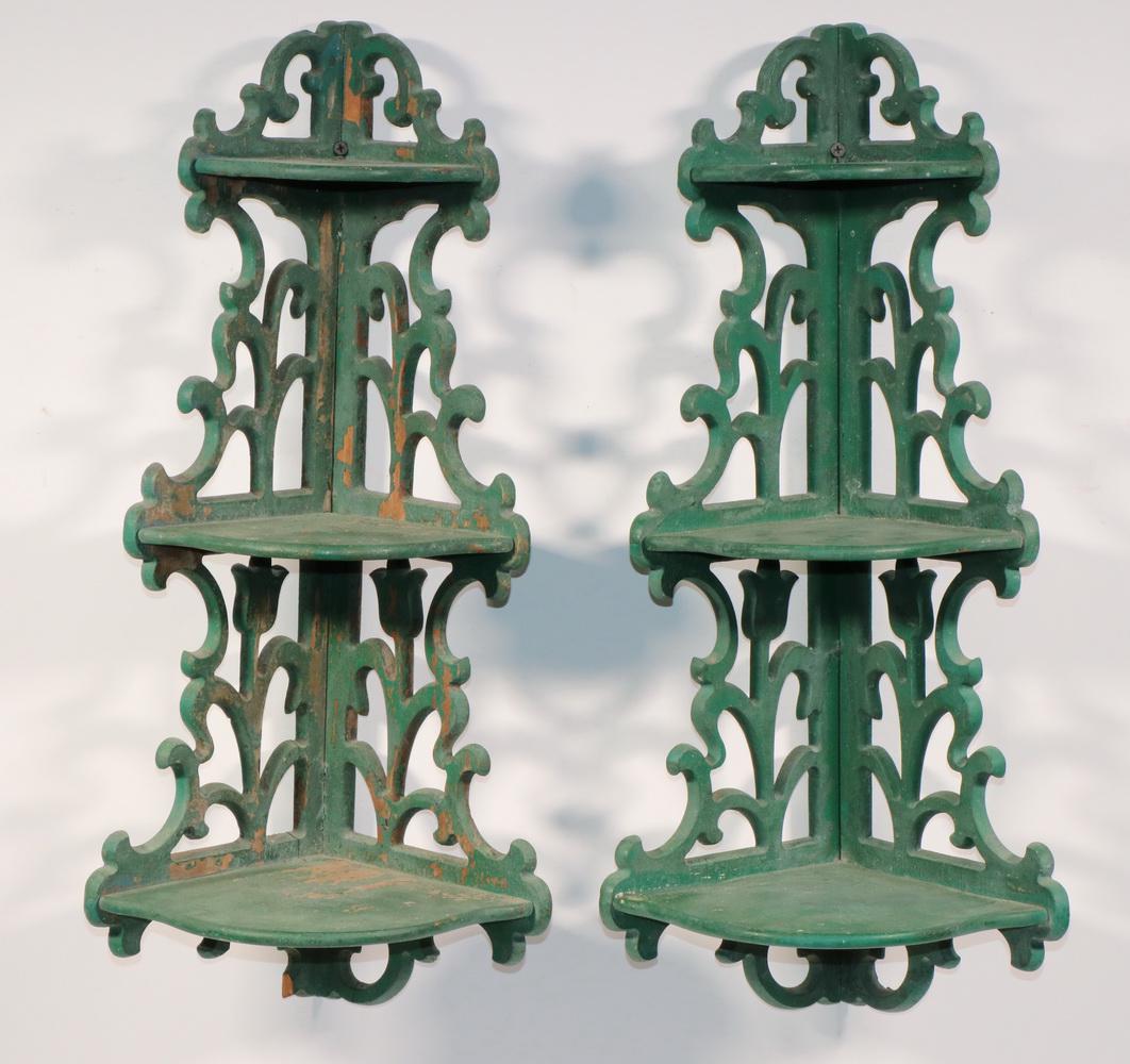PR OF THREE-TIERED CORNER WALL SHELVES IN GREEN PAINTED: Fretwork brackets circa 1920s, featuring tulips, cyma curved graduated shelves, 22" x 7" x 7". Good condition.