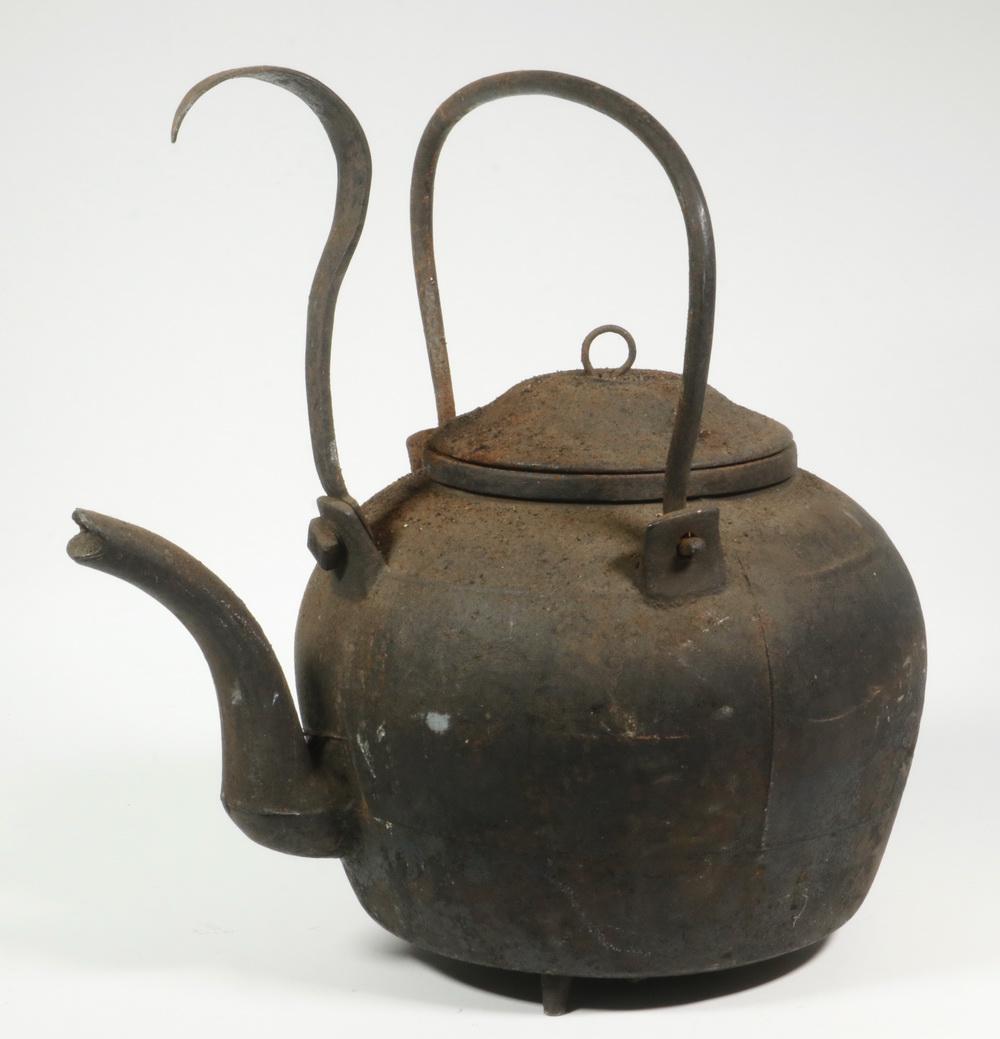 EARLY IRON KETTLE: Late 18th - Early 19th c. Cast Iron Hearth Kettle, tripod base, with iron tilter and swing handle, 14" high, 13 1/2" x 9 1/2", Surface rust.