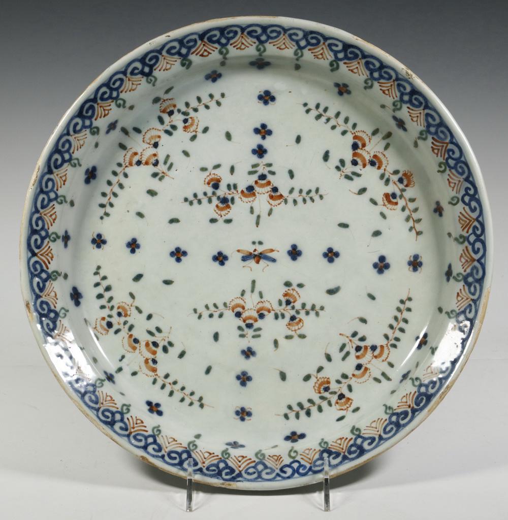EARLY FAIENCE CHARGER: 18th c. Continental Polychrome Tin Glazed Earthenware Charger, probably French, with blue, red and green floral decoration, 13" diam. Rim glaze frits.