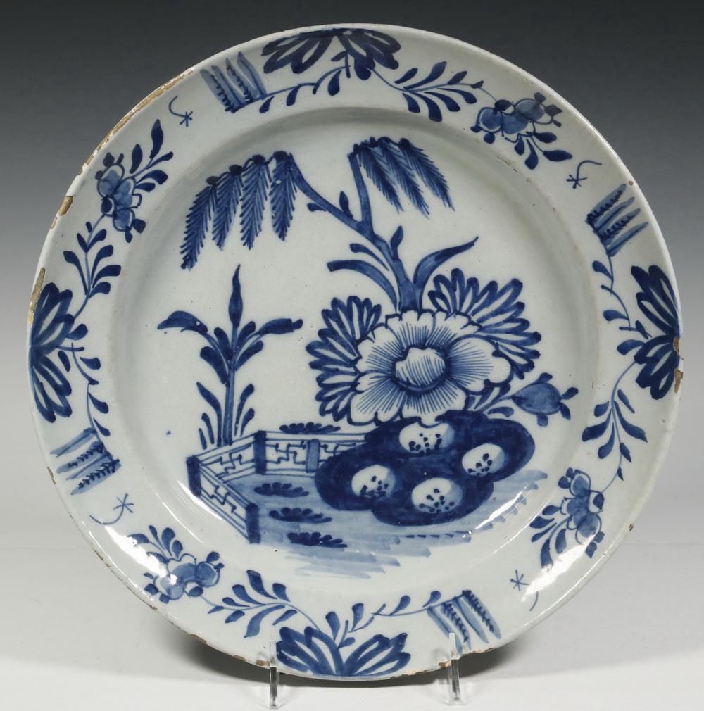 DUTCH DELFT CHARGER: 18th c. Dutch Blue and White Delft Charger, with floral and landscape decoration, 13 1/2" diam. Large under-edge rim chips, glaze frits.