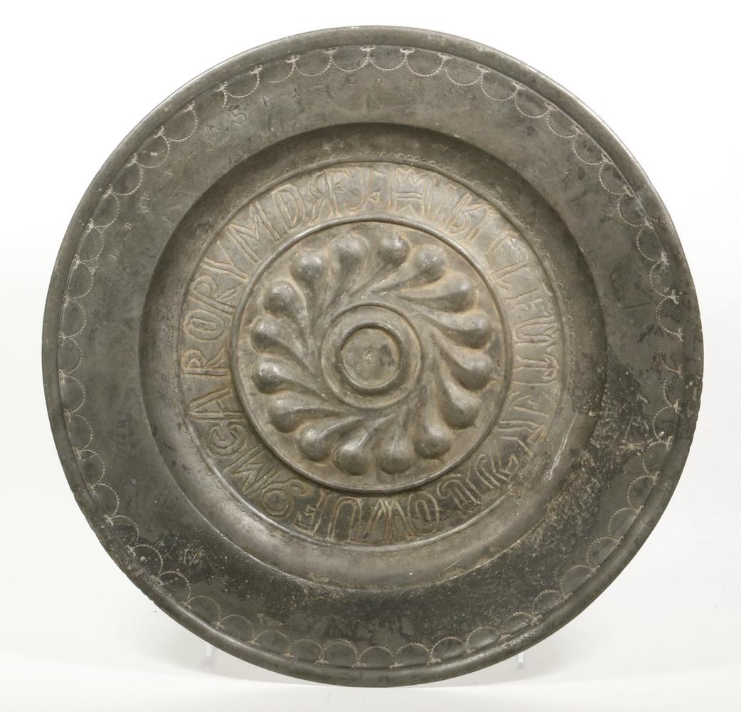 EARLY COPPER ALLOY ALMS BASIN: 16th c. Round Metal Alms Dish, probably Nuremburg, repousse rosette center surrounded by incised letters, rim engraved 'IBVV - 1561 - LOI', engraved scalloped decoration at rim, 15 1/4" diam. Surface 