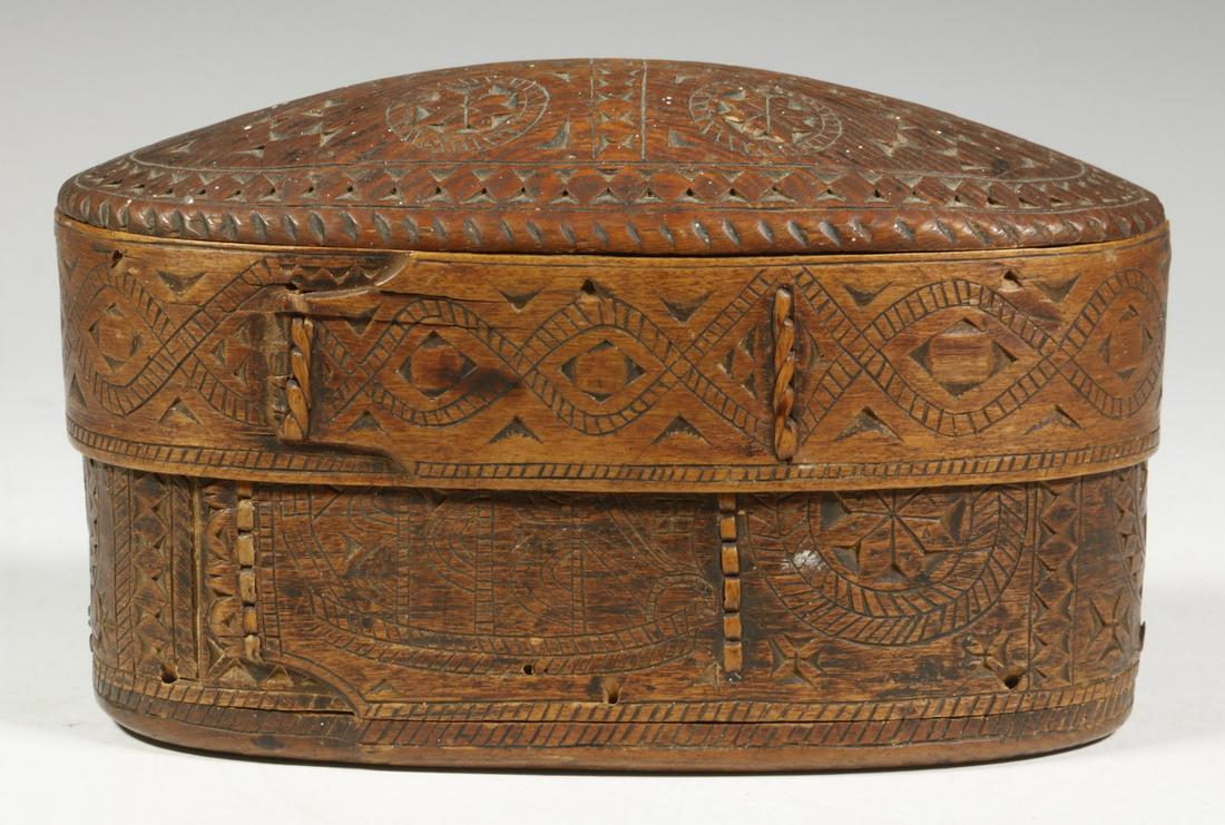 SCANDINAVIAN CARVED PANTRY BOX: 19th c. Chip Carved Oval Bent Wood Pantry Box, with domed lid, ornate surface decoration, tightly stitched joints, incised partial Roman numeral date on base (poss. 1830), 4" high, 6 5/8" x 3 1/2". Go