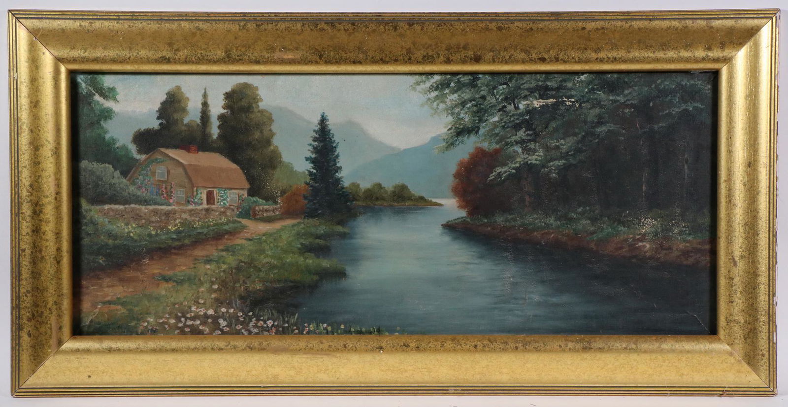 IDYLLIC LANDSCAPE WITH STREAM FRONT COTTAGE: Spring Flower Bedecked Valley with stone hipped roof cottage on stream path, distant mountains, circa 1930s, unsigned, in later gold ogee frame, OS: 19 1/2" x 38 1/2", SS: 13" x 32". Some flaking.