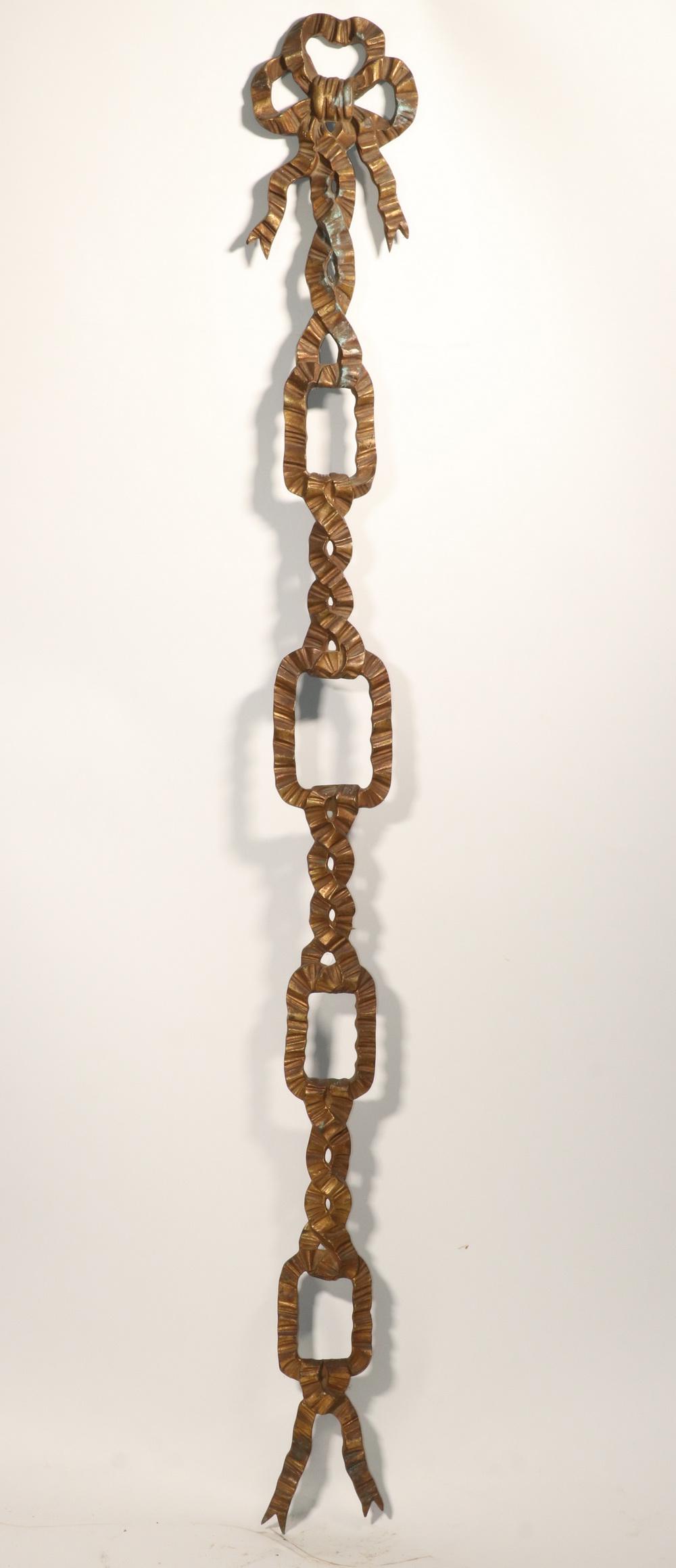 LARGE GILDED CAST BRASS RIBBON FORM WALL DECORATION: French Style Ribbon Drop with open cartouches for four portraits or other decorative elements, 66" x 8". Good condition.