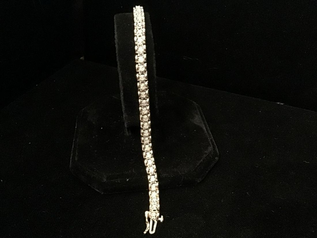 DIAMOND BRACELET: Contemporary Design 14K Gold and Diamond Line Bracelet, set with (46) small round diamonds, approx. 2.0 ct., 6.1 dwt, 1/4" wide, 7" long. Very good condition.