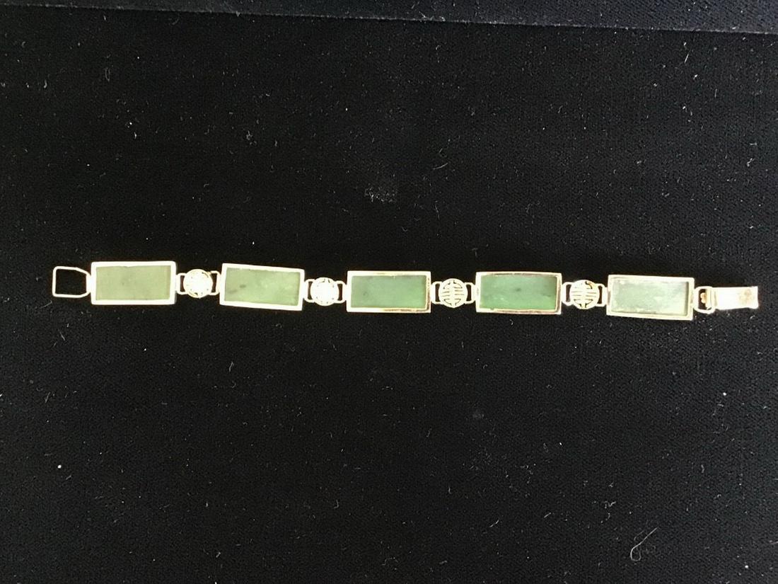 JADE BRACELET: Vintage Chinese 14K Gold and Carved Jade Bracelet, set with (5) rectangular engraved jade links with (4) round gold spacers, 8.9 dwt. overall, circa 1940/50s, 1/4" wide, 7" long. Very good condition.