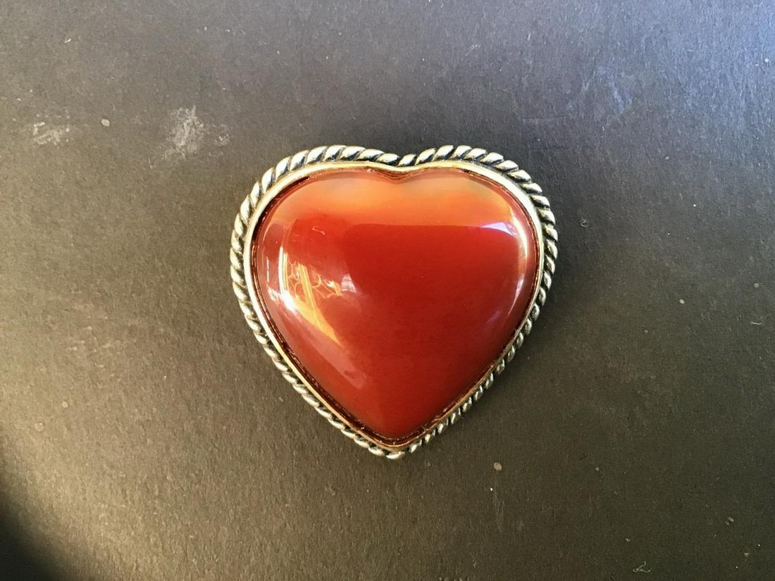 HEART BROOCH: A Heart Shaped Brooch, set with a carnelian stone, circa 1950, 1 1/2" high, 1 1/4" wide. Fine condition.