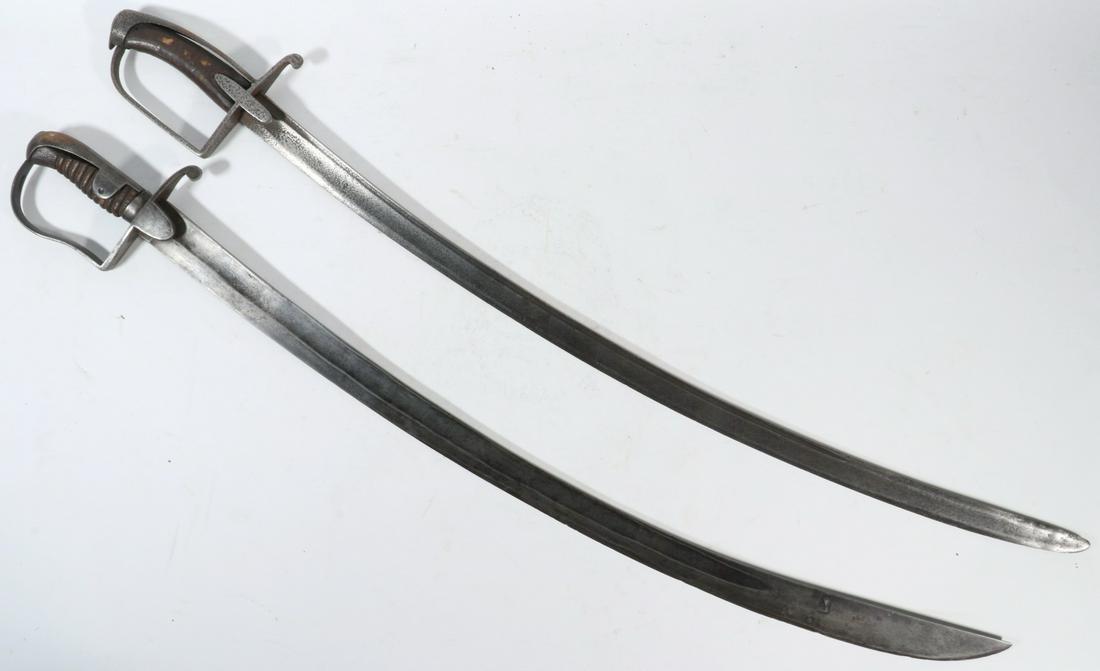 (2) NAPOLEONIC ERA FRENCH CAVALRY SABRES: Hussar Cavalry Sabres with variations, having large curved deep fuller blades, iron hilts with wooden grips, no maker's marks, no scabbards, both 38" long overall. Corrosion, pitting.