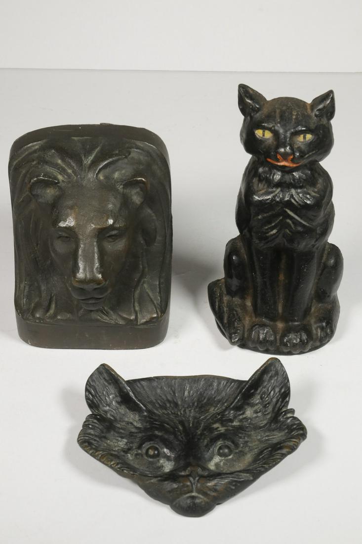 (3 PCS) BRONZE & IRON CAT ACCESSORIES: Group of (3) Feline Decorative Objects, incl: Vintage iron seated black cat doorstop, 6 1/2" high; Bronze lion head doorstop or bookend, with felted base and back, 4 3/4" high; and Bronze cat head for