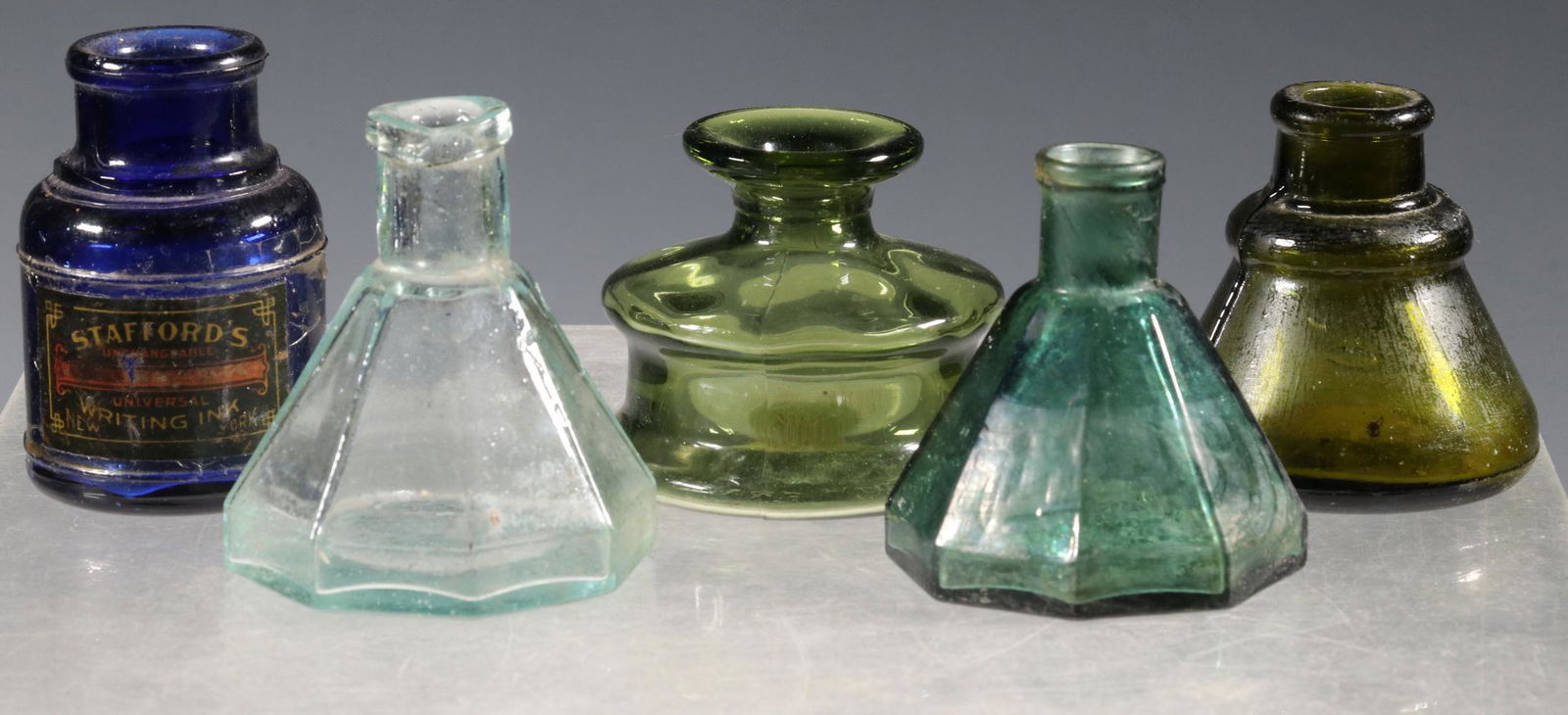 (5) GLASS INK BOTTLES: Group of (5) Assorted Glass Ink Bottles, incl: 19th c. teal green umbrella form blown ink bottle, octagonal base, open pontil scar, 2 1/2" high, 2 1/4" diam., cloudy interior base; Aqua green umbrella