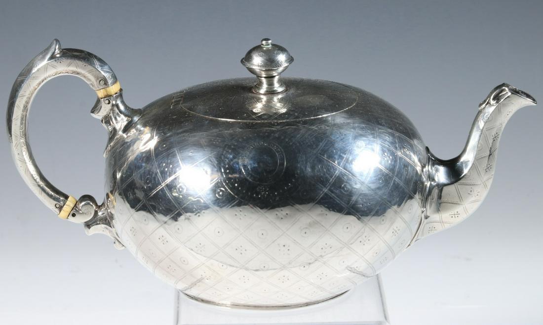 VICTORIAN SILVER TEAPOT BY ROBERT HARPER: English Sterling Silver Bullet Form Teapot, by Robert Harper, London 1862 hallmarks, with engine turned engraved surface and crest with bird and motto "In Domino Confido" (In God I Trust), possibly fo