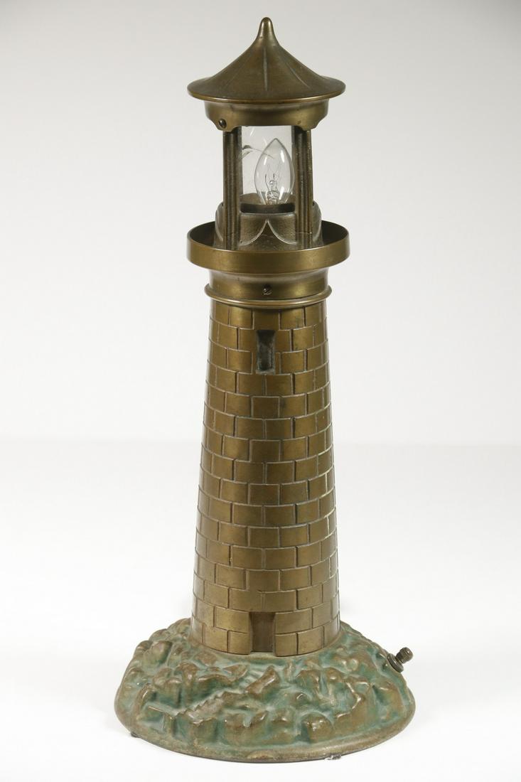 BRASS LIGHTHOUSE FORM LAMP: Electric 'TV Light', meant to ease the eyes from watching an early screen, this in solid brass with a painted cast iron base, with single small candelabra lamp in the top, twist switch lower back, cir