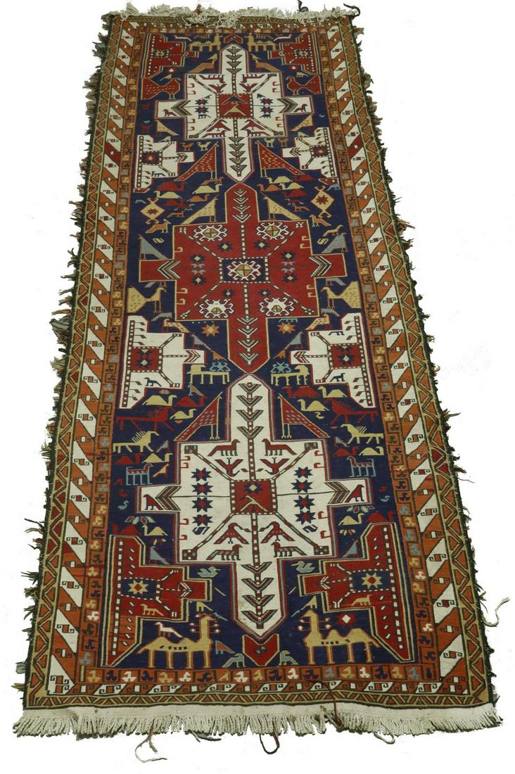 SOUMAK RUNNER - 3'-2" x 8': Northeast Caucasus, mid-20th c., three gabled square medallions in ivory and red on the cobalt blue field, decorated with camels, birds and horses, in sky blue, rust, ivory and gold, rust and ivory ba