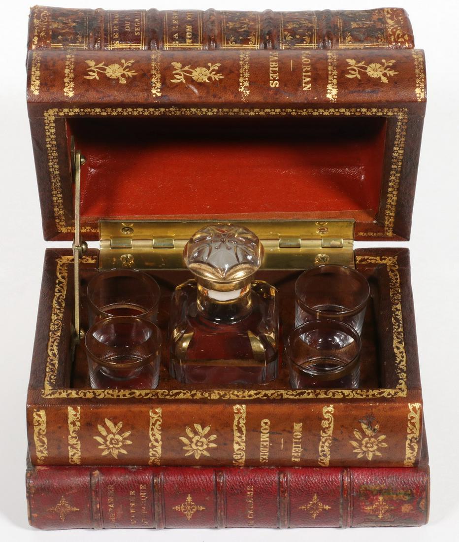 FRENCH LEATHER BOOK CASED CORDIAL SET: Vintage (5) Piece Crystal Cordial Set, circa 1950s, inside a fitted case with leather bound book form exterior, hinged lid, with square stoppered decanter (4 5/8" high) and four small glasses (2" high