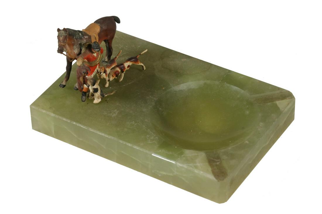 ONYX ASHTRAY WITH COLD PAINTED BRONZE HUNTING FIGURES: Vintage Carved Green Onyx Ashtray, with attached Austrian cold painted bronze fox hunting figures, including hunter, horse, hounds and fox, felted base, 3 1/4" high, 6" x 4". One leg of horse detached