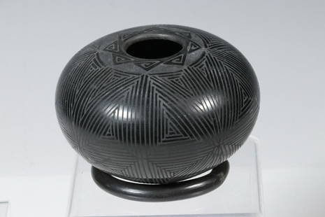 OCTAVIO ANDREW BLACK POTTERY JAR: Mata Ortiz style Seed Pot, Black on black, decorated with a fine line and geometric design, signed on the underside, 3" x 4" diam. Good condition.Octavio Andrew is a potter living and working in the v