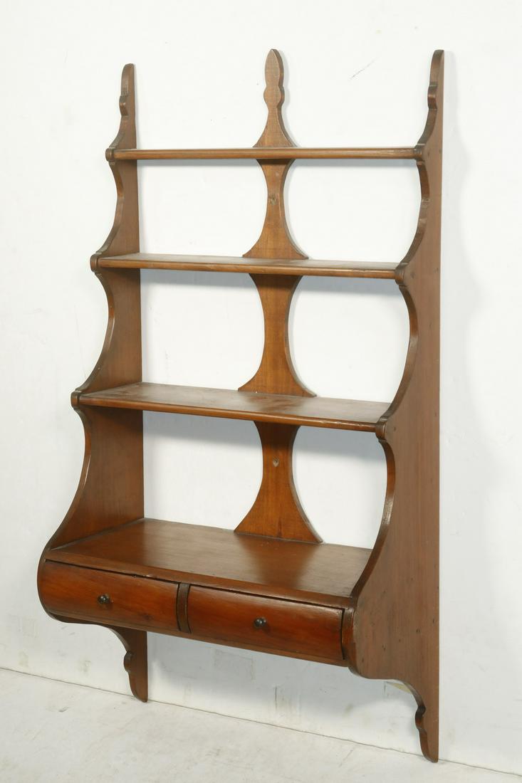 WOODEN WALL SHELF: Circa 1920s Hanging What Not Shelf, with four shelves above two drawers, three finial top and shaped sides, 32" high, 16 3/4" x 8". Good condition.