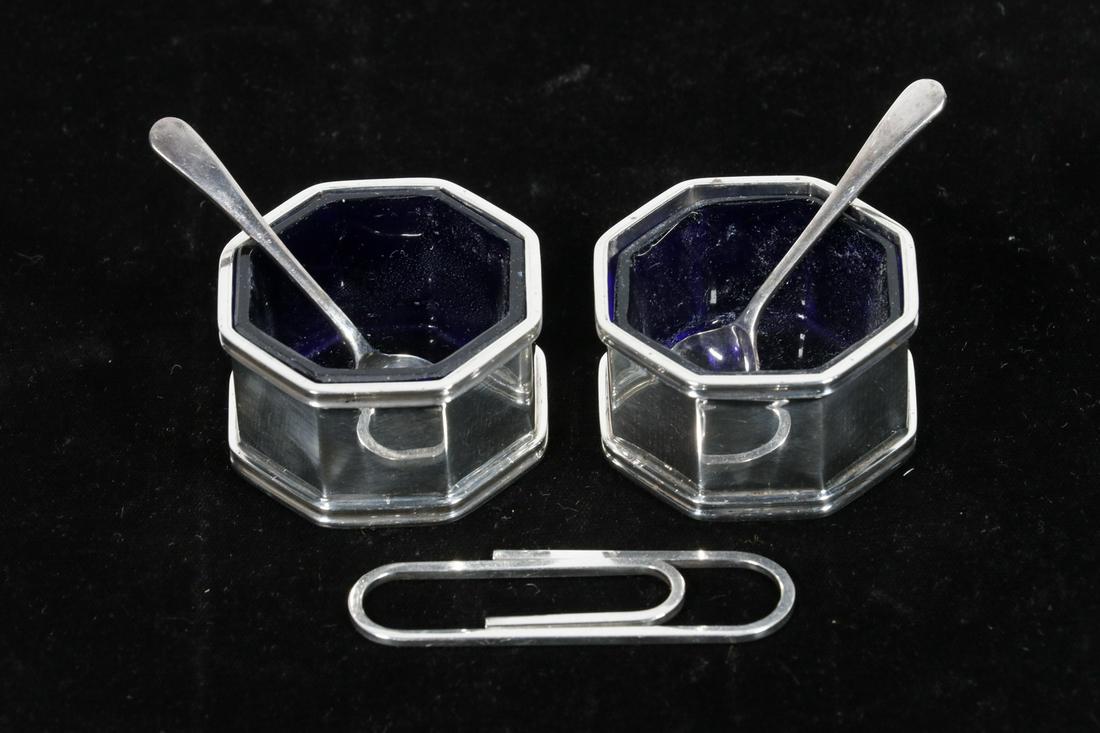 (3 PCS) TIFFANY & CO. STERLING - MONEY CLIP & SALT: Lot of (3) Sterling Silver Accessories by Tiffany & Co., incl: Paper clip form money clip, 2 1/2" x 3/4"; and Pair of octagonal salt cellars with blue cobalt glass liners, also with silver-plate spoon