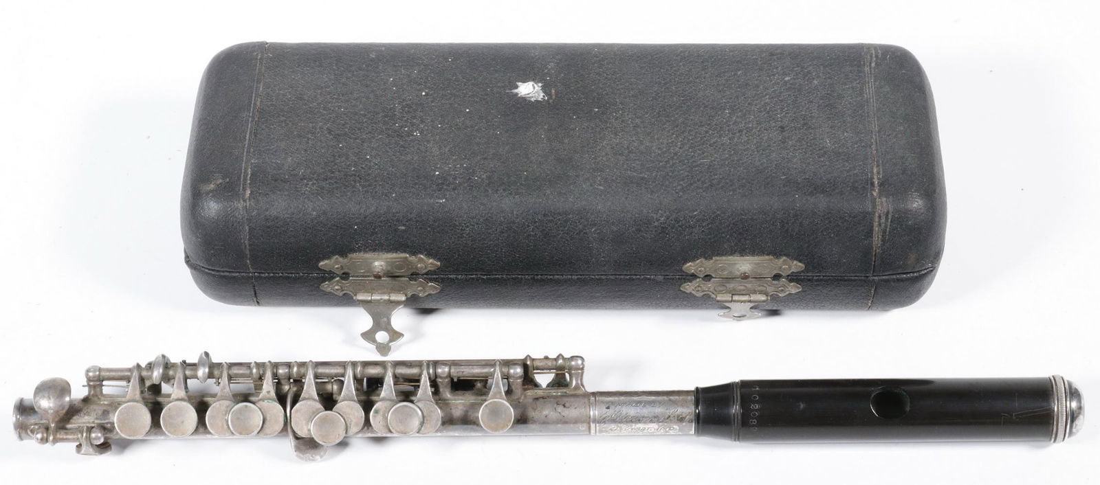 1907 CONN PICCOLO IN CASE: Silver-Plated Piccolo, engraved "Made by C.G. Conn, Ltd., Elkhart, Ind., USA", s/n 102089 (manufactured in 1907), with gutta percha lip rest. 8 1/2" long case. Needs cleaning.