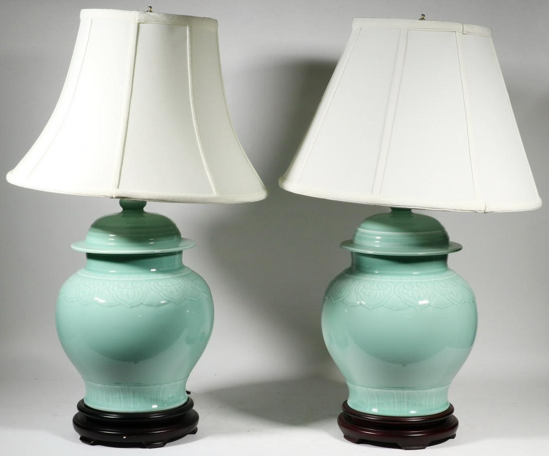 PR CELADON GINGER JAR TABLE LAMPS WITH SIMILAR SILK: Pair of Celadon Glazed Ginger Jar Form Pottery Table Lamps, late 20th c., each with molded ruyi form decoration surrounding shoulder, set on wooden bases, single socket fixture with harp and finial, i