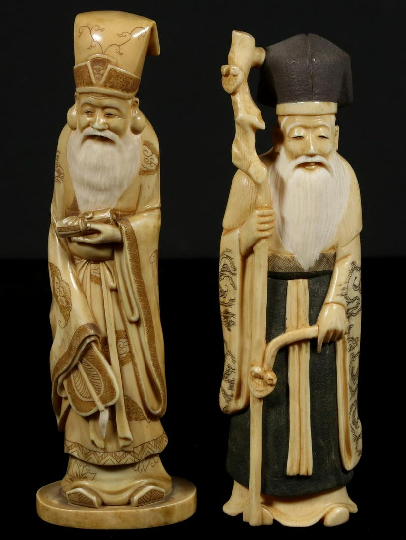 PR OF CARVED BONE JAPANESE CONFUCIAN SCHOLARS: Two Standing Scholars, carved with scrimshawn and inked detail, signed on the underside, one with black painted skirt and head covering, both with long white painted beards, one holding staff and scep