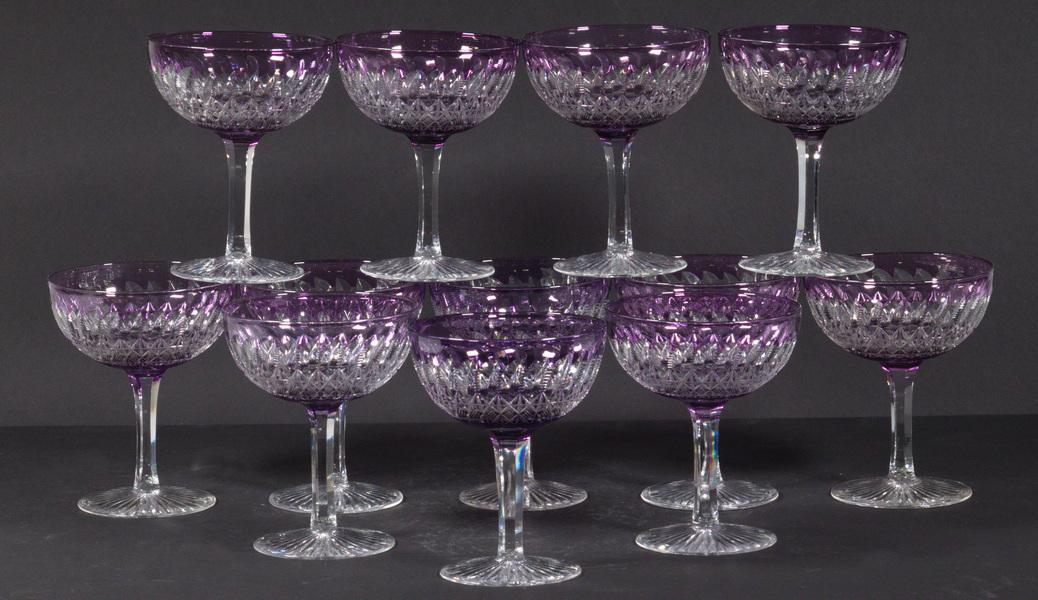 ANTIQUE THOMAS WEBB CUT TO CLEAR CRYSTAL CHAMPAGNES: Lot of (12) Webb English Amethyst Cut to Clear Champagne Glasses, mid-20th c., with clear stem and foot, acid etched round 'Webb, Made in England' mark, 5" high, 4" diam. Good condition.