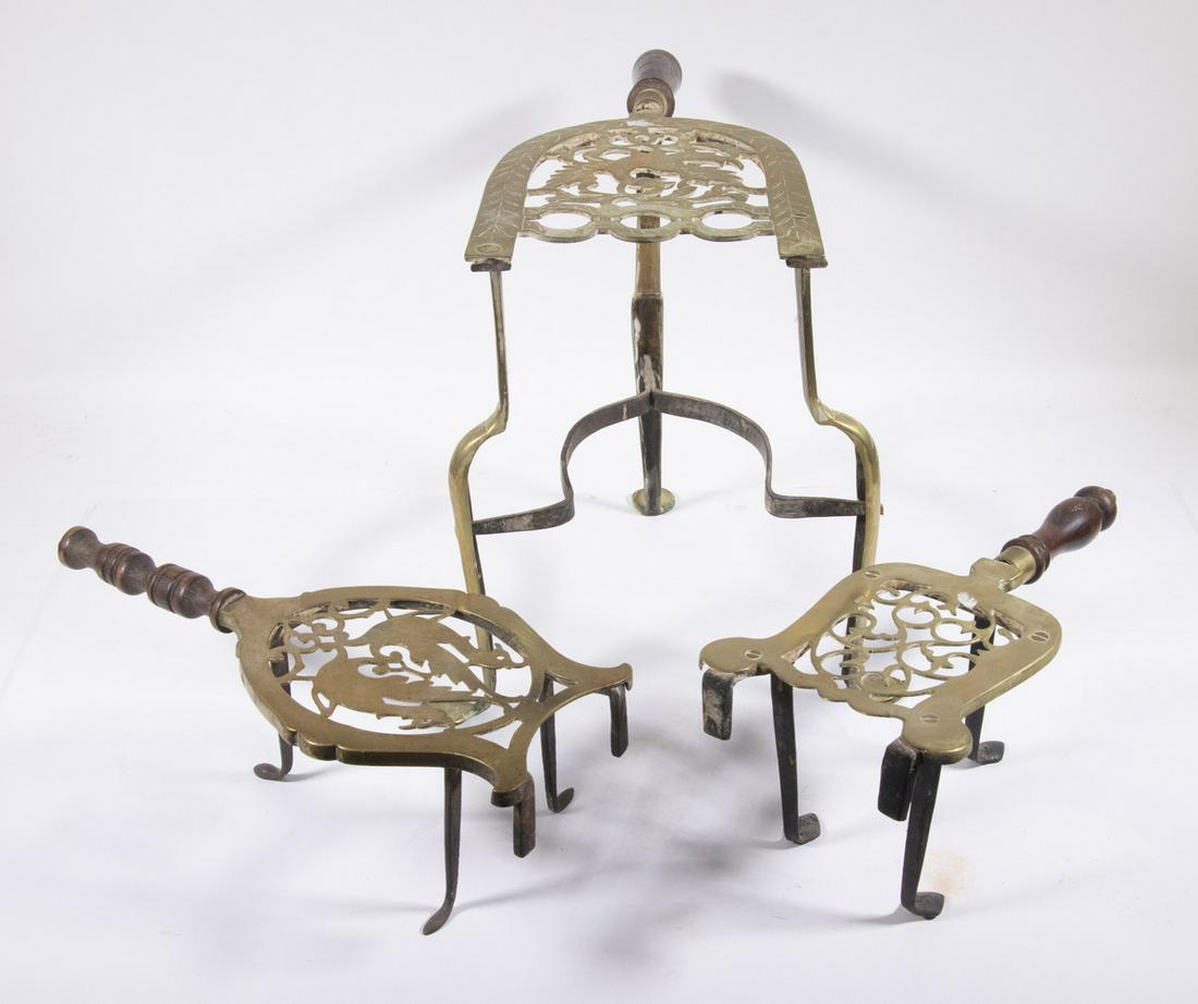EARLY BRASS & IRON KETTLE TRIVETS: Group of (3) 18th -19th c. Kettle Stands, with pierced brass tops, turned wooden handles, iron legs, 4 1/2" to 11 3/4" high. Surface wear.