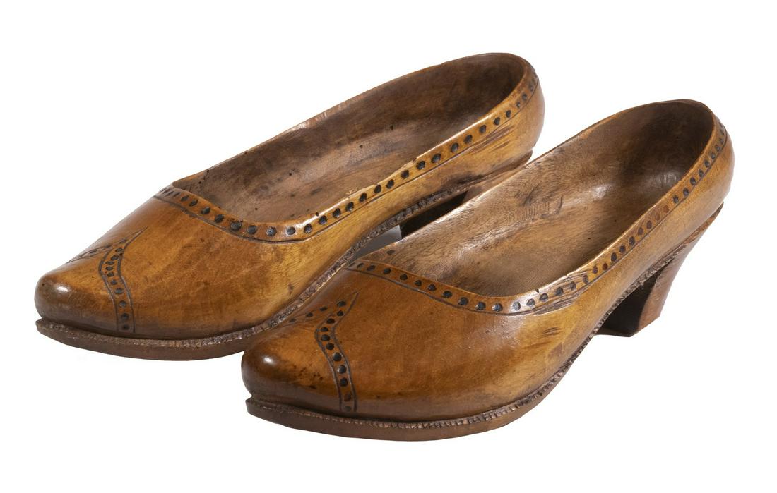 PR WOODEN HIGH HEEL SHOES: Pair of Vintage Carved Women's Shoes, based on a spectator shoe design, each carved from a single piece of wood, 10" long, 3 1/2" wide, 2" high heels. Worm damage; one side edge chip and one heel edge