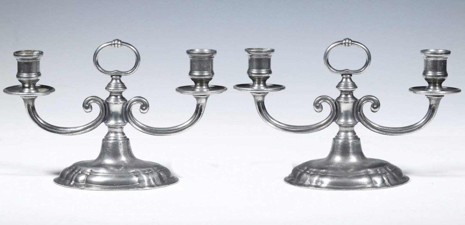 PR CANDLESTICKS: Pair of matching contemporary pewter, two armed candlesticks, illegibly signed. 6 1/2" x 9". Good condition.