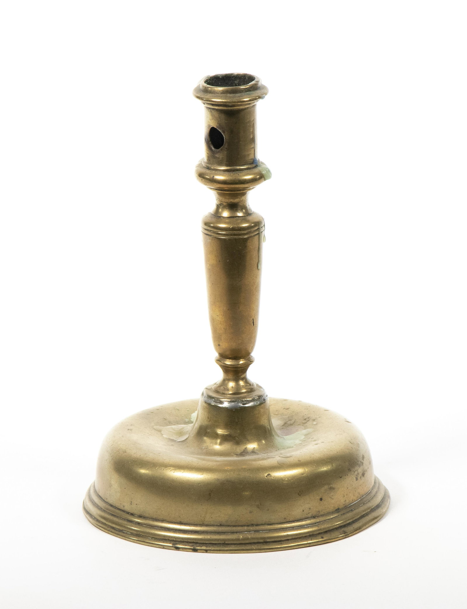 17TH C. BRASS CANDLESTICK: Early Bell-Form Candlestick, probably Dutch, with large ejector holes, baluster stem, 7 1/2" high, 5 1/4" diam. Solder repair between stem and base.