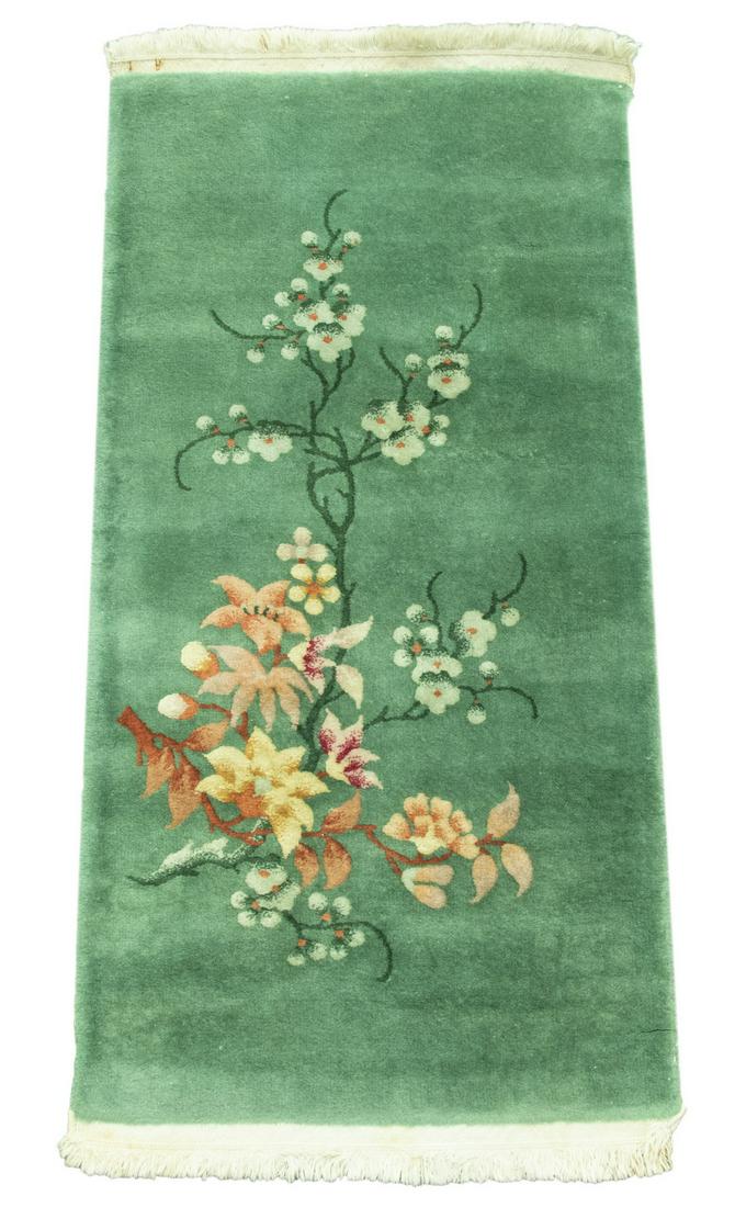 CHINESE RUNNER: Open sage green field decorated with a lotus tree in gold, rose, rust-red and forest green, no border, 2' x 4'. Good condition, minor wear to selvage.