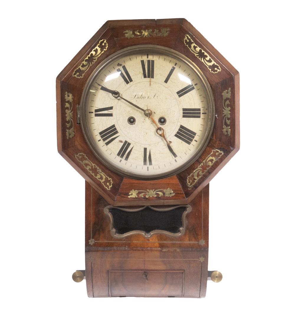 BRASS INLAID PENDULUM WALL CLOCK, BY BEHA & CO., GERMANY, CA. 1880: Rosewood Fronted Case with octagonal dial frame having brass floral inlay, butterfly shaped brass trimmed pendulum window, convex inturned bottom with beaded door to access pendulum, which is present,