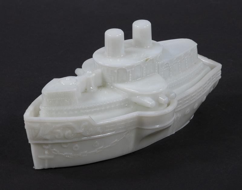 MILK GLASS BATTLESHIP MAINE LIDDED DISH: Circa 1900 Milk Glass Lidded Candy Dish, commemorating the Spanish American War sinking of the Battleship Maine in 1898, 3 1/2" high, 7 3/4" x 4". Good condition.