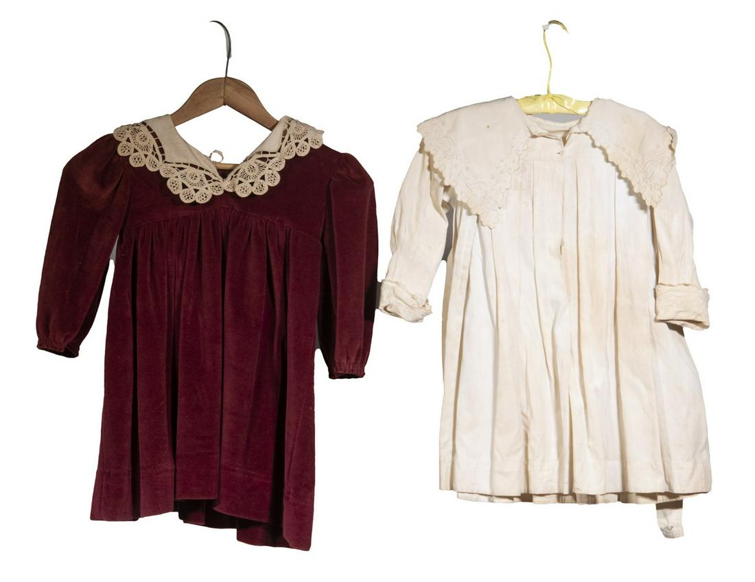 (2) VINTAGE CHILD DRESSES: Including: Burgundy velvet with linen and lace collar, 23" long; and Off white summer dress with self tie, embroidered collar and cuffs, 20 1/2" long. Stains and toning.