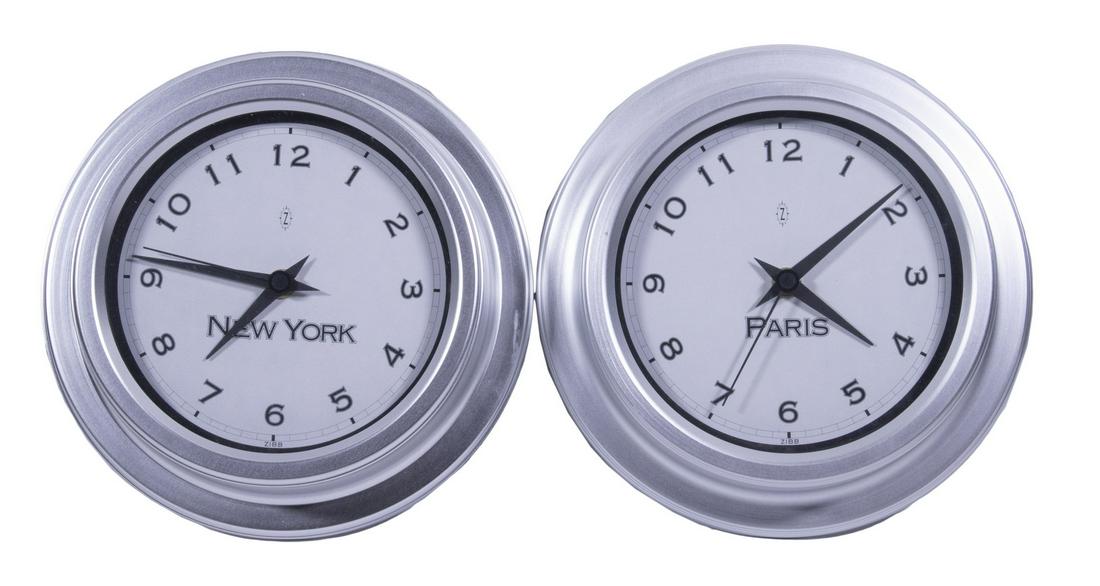 TIME ZONE WALL CLOCKS BY CORKERY-MACKAY: Lot of (2), labeled "New York" and "Paris", each with AA battery operated quartz movement, brushed aluminum case, made in the UK, 8 3/4" diam. Good condition.