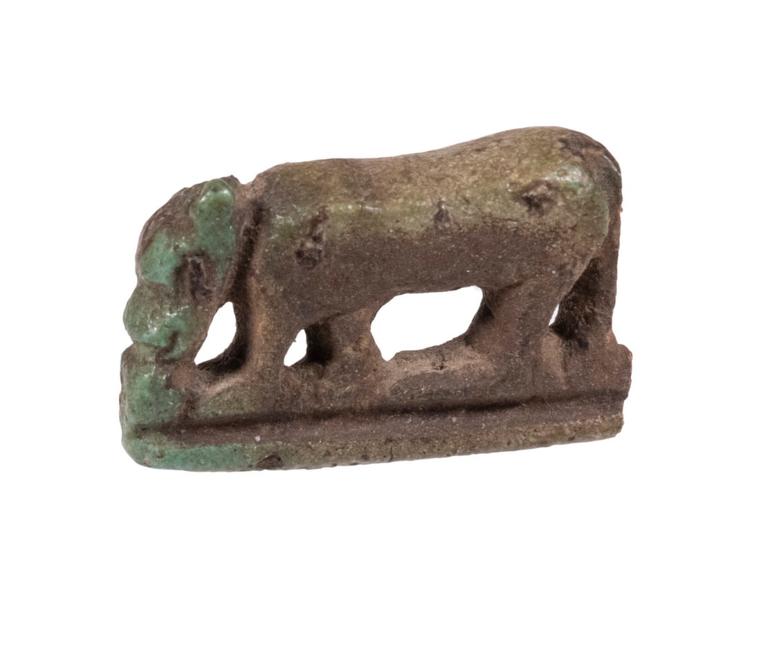 ANCIENT EGYPTIAN FAIENCE AMULET OF A JACKAL: Small naturalistic figure of a Jackal (or dog) eating, an unusual form, on integral base, in turquoise glaze, 1 5/8" long. Good condition.