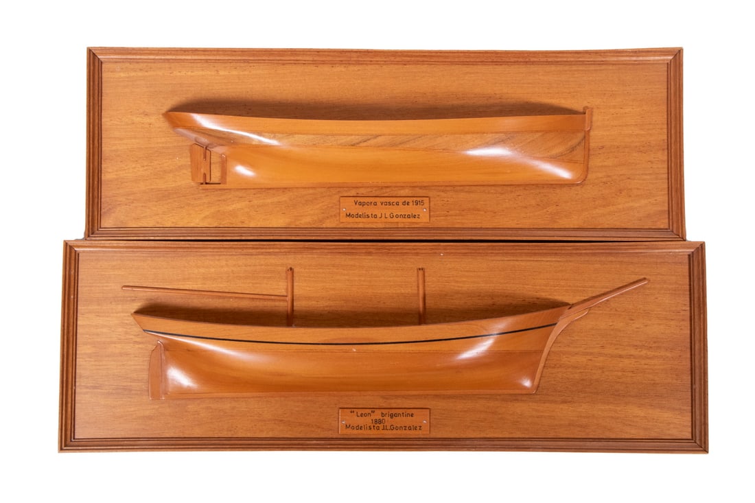PR MINIATURE HALF HULL MODELS: Pair of Finely Crafted Ship Models, depicting the 1880 brigantine "Leon", and "Vapora Vasca de 1915", crafted by J.L. Gonzalez, with affixed plaques, both on framed mahogany backing, 4 1/2" x 13 1/2"
