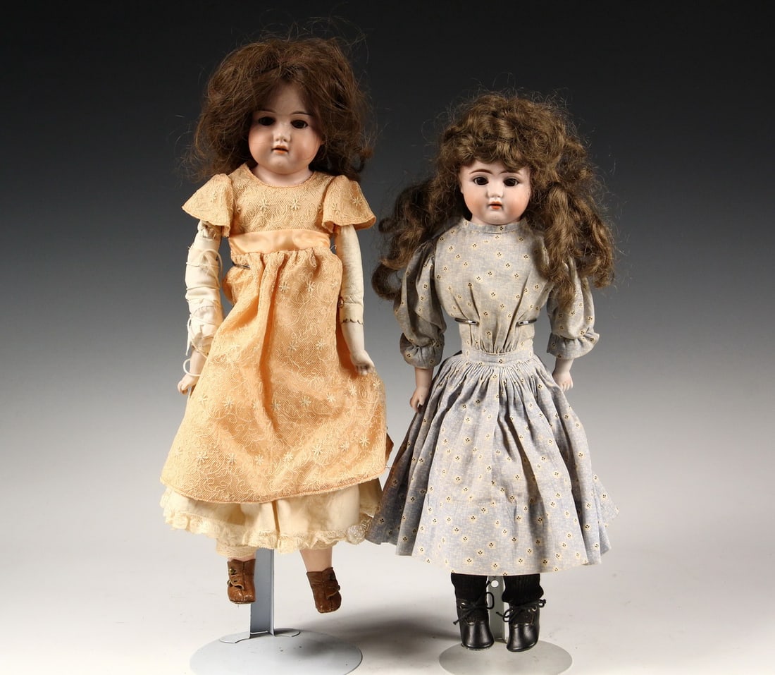 (2) ANTIQUE BISQUE DOLLS: Including: 18" Armand Marseille, marked "370 AM2.OX Dp", with brown sleep eyes, open mouth with upper teeth, replaced hair, bisque hands, cloth body, composition legs, later orange dress, brown leathe