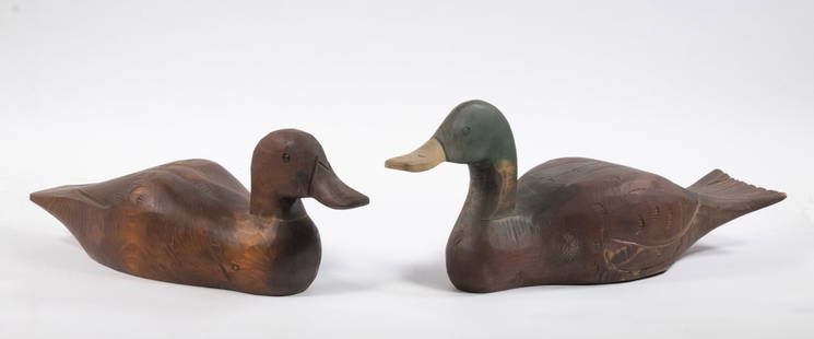(2) CARVED DUCK DECOYS: Lot of (2) Decoys, both with carved feather detail, incl: Unpainted decoy with glass eyes, stamped "Made in Canada" on base, 5 3/4" high, 14 1/2" long, shrinkage crack to one side, surface wear; and M