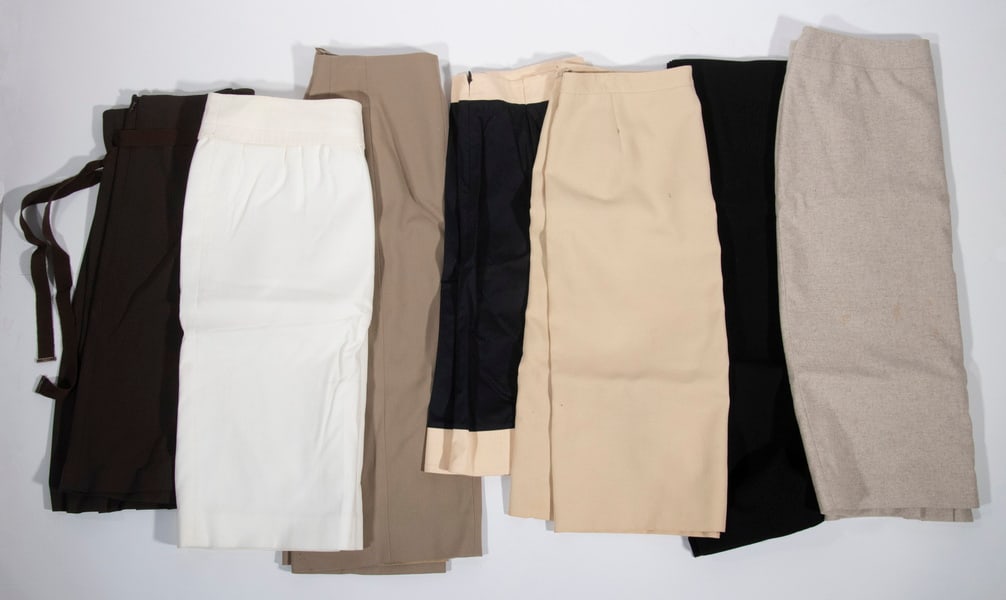 A COLLECTION OF (7) LADIES SALVATORE FERRAGAMO SKIRTS: Lot of (7) ladies Salvatore Ferragamo skirts. (1) Navy blue A-line skirt with cream waist and hem. US 14, 95% cotton, 5% spandex. 23" length, 16.5" waist, 34" hem. Small stain on the front. (1) Black