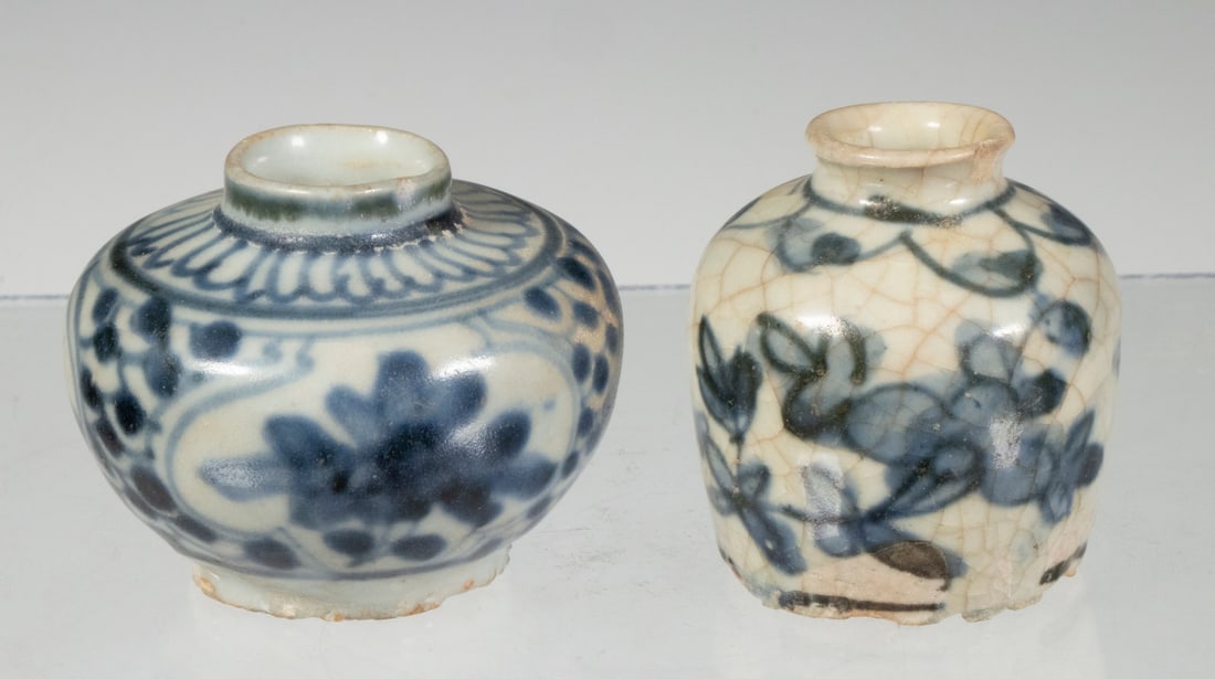 (2) CHINESE MINIATURE BLUE AND WHITE PORCELAIN JARS: (2) CHINESE MINIATURE BLUE AND WHITE PORCELAIN JARSBlue and White Glazed jars with floral motif, with shaped lips, 2" high, 2 1/4" diam. and 2" high, 1 3/4" diam. One has rim chips.