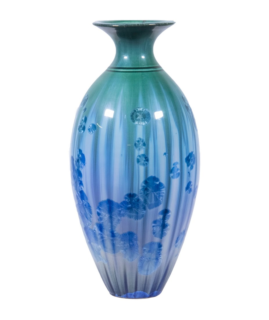 ART POTTERY VASE: ART POTTERY VASEMaine Artisan Crafted Porcelain Vessel, probably Edgecomb pottery, elegant ovoid shape with flared rim, having white streamed glaze with blue orchid form floral motifs over a glossy gr