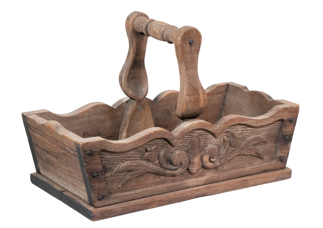 CARVED WOODEN BASKET: CARVED WOODEN BASKET Rectangular Holder, with shaped fixed handle and rim, floral carved sides. Base shrinkage crack. OS: 14 x 21 1/2 x 10 in. (35.6 x 54.6 x 25.4 cm.)