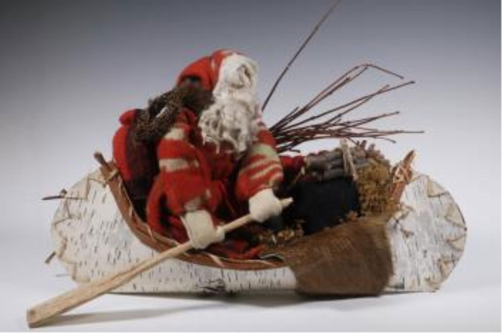 CHRISTMAS DECORATION: CHRISTMAS DECORATION Handmade decoration, three dimensional, depicting Santa with packs rowing in birch bark canoe.