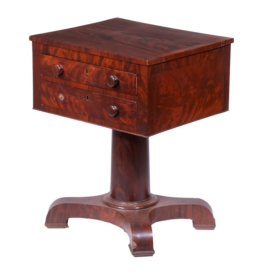 EMPIRE MAHOGANY STAND: EMPIRE MAHOGANY STAND Early 19th c. Two-Drawer Stand, in figured mahogany, with crossbanded flame veneered top, wooden mushroom form drawer pulls, tapered cylindrical pedestal, set on a base with