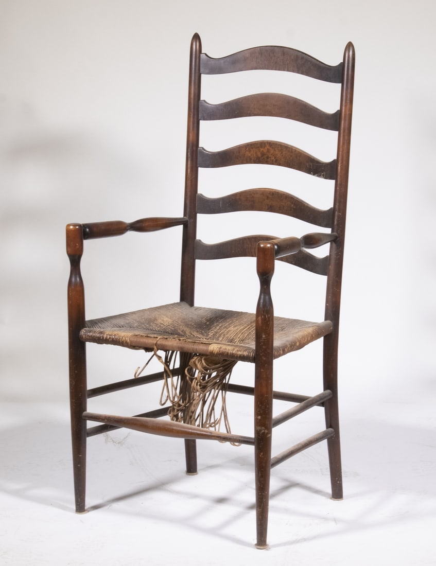 TALL SLAT BACK RUSH SEAT AMERICAN ARMCHAIR: TALL SLAT BACK RUSH SEAT AMERICAN ARMCHAIR Walnut Stained Maple with peaked rails, five arched slat back, turned arms with dimpled center, dimpled arm supports. Rush seat needs replacement, bowed