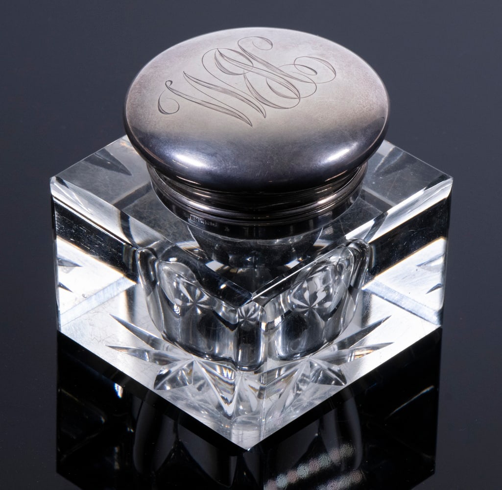 STERLING TOPPED CRYSTAL INKWELL: STERLING TOPPED CRYSTAL INKWELL Cube Form Clear Crystal Inkwell, with hinged sterling silver lid with engraved monogram, the crystal base with beveled edges and star cut underside. 3 x 3 x 3 in. (7.6