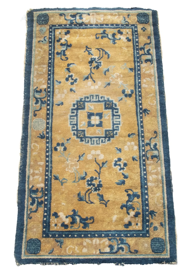 CHINESE MAT: CHINESE MAT Chinese manufacture, late 19th c. Featuring navy blue and gold circular medallion on the gold field with a gold meander border. Overall even wear with some minor end loss and salvage loss.