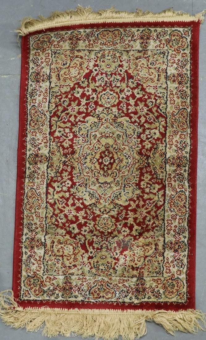 MACHINE MADE MAT: MACHINE MADE MAT Kashan design, tan-gold medallion on the red field. Good condition. OS: 19 x 33 in. (48.3 x 83.8 cm.)